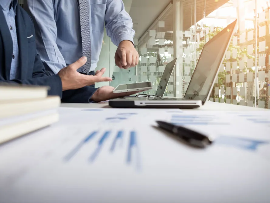 Reviewing retirement finances with charts and a laptop