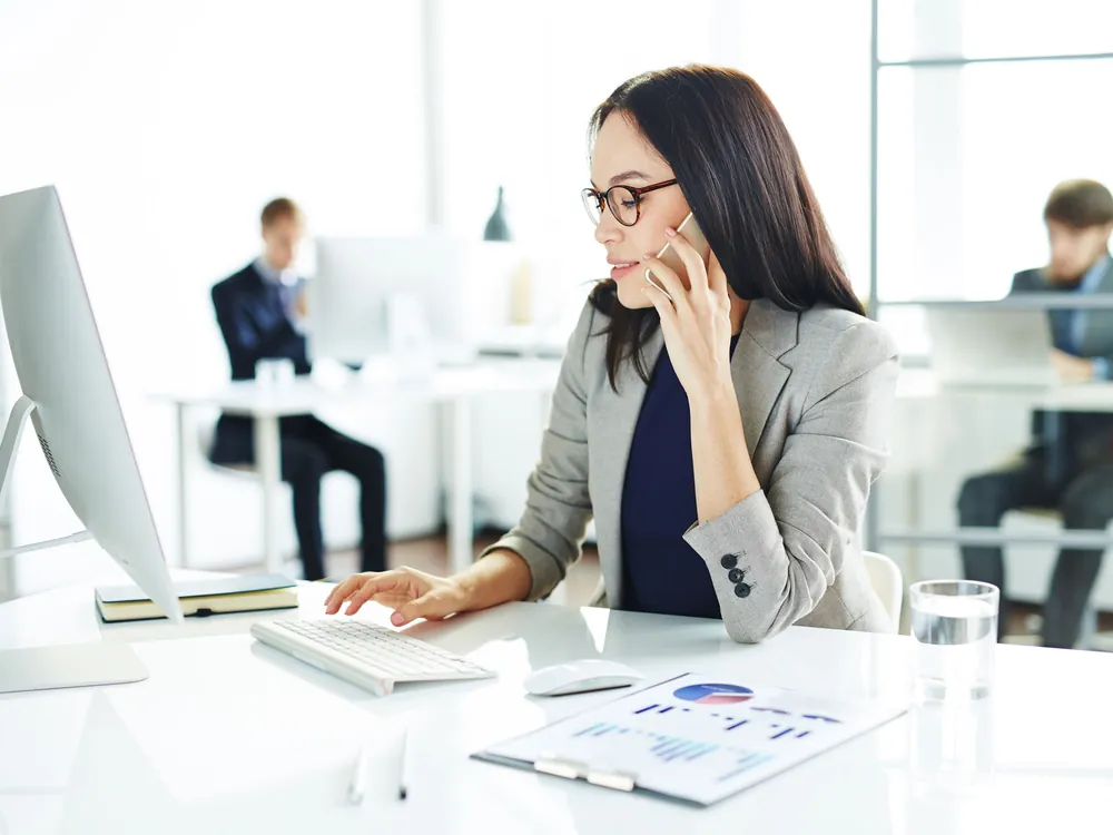 Woman taking a call at her desk